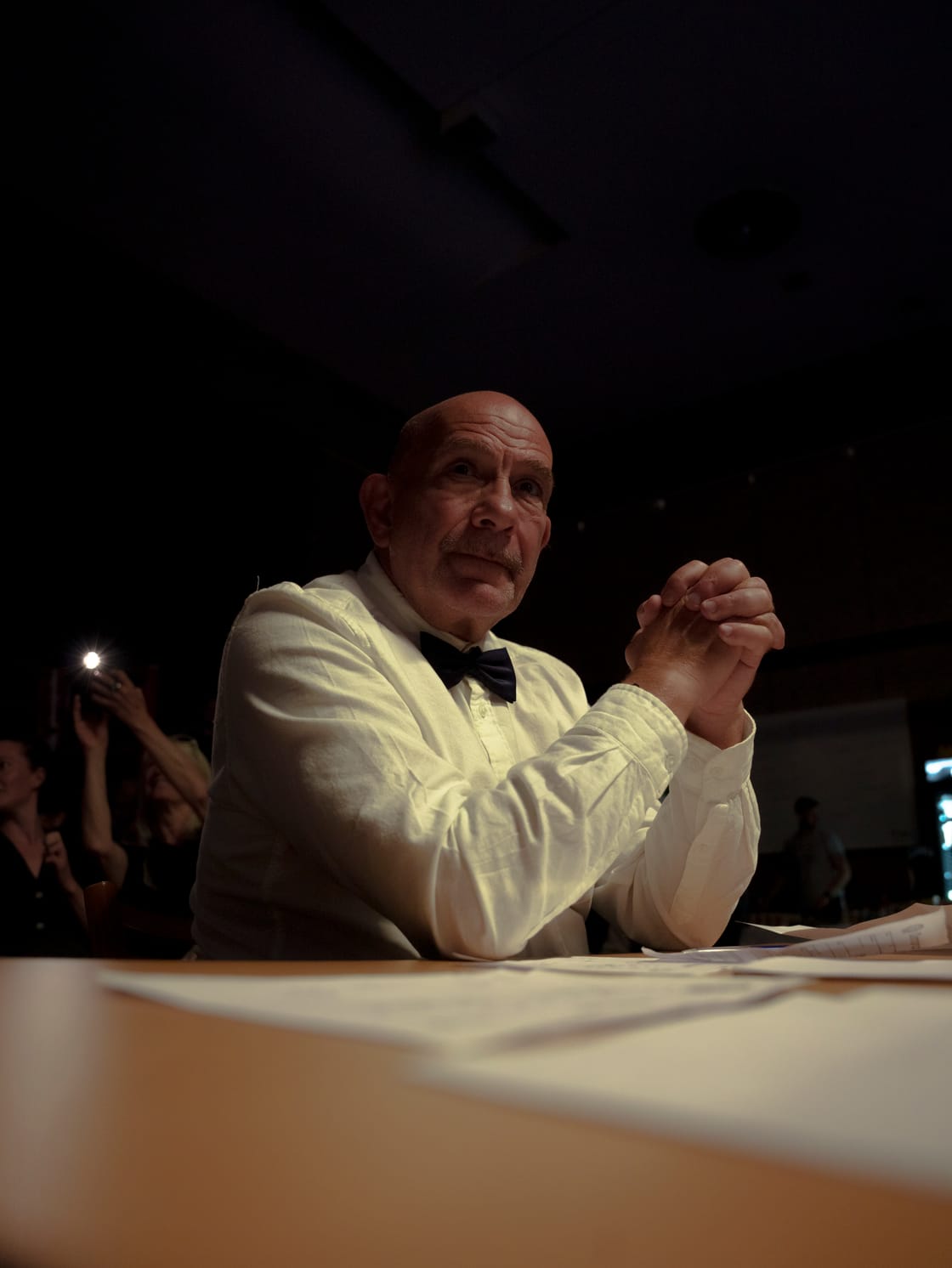 Seated judge watching a live stage performance.