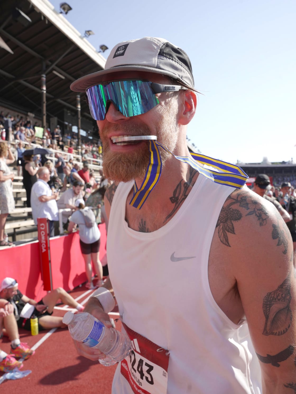 Runner wearing his medal after a track event.